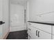 Modern bathroom with a dark tiled floor and a white vanity at 1145 Kingston Drive, Atlanta, GA 30342