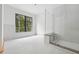New construction bathroom featuring glass shower with bench, and a large window view at 1145 Kingston Drive, Atlanta, GA 30342