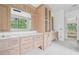 Bathroom featuring vanity with marble countertop, drawers, cabinets, and a large mirror at 1145 Kingston Drive, Atlanta, GA 30342