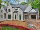 New construction home with white painted brick, black window trim, and two-car garage at 1145 Kingston Drive, Atlanta, GA 30342