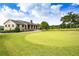 Charming stone building overlooking a pristine putting green with mature trees and a flag pole at 1145 Kingston Drive, Atlanta, GA 30342