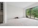 Brightly lit room with a large window overlooking green foliage at 1145 Kingston Drive, Atlanta, GA 30342