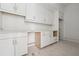 White cabinets and drawers with stainless steel hardware offer plenty of storage in the kitchen at 1145 Kingston Drive, Atlanta, GA 30342