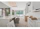 Spacious kitchen features a large island with a marble countertop and black framed windows at 1145 Kingston Drive, Atlanta, GA 30342