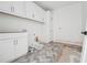 Laundry room featuring tiled floors, and white cabinets awaiting appliances at 1145 Kingston Drive, Atlanta, GA 30342