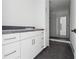Laundry room featuring tiled floors, and white cabinets at 1145 Kingston Drive, Atlanta, GA 30342