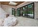 Bright room featuring white brick, wood ceiling, and an expansive window to view outdoors at 1145 Kingston Drive, Atlanta, GA 30342
