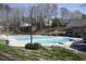 Large outdoor pool, offering a refreshing escape surrounded by green trees and lawn at 1145 Kingston Drive, Atlanta, GA 30342