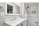 Modern bathroom featuring a stylish vanity, mirror, and a walk-in shower with elegant white tiling, creating a spa-like feel at 1434 Churchill Way, Marietta, GA 30062