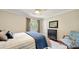 Bright bedroom featuring a comfortable bed, dresser, and a stylish armchair, all complemented by natural light at 1434 Churchill Way, Marietta, GA 30062