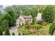 Charming traditional home featuring lush landscaping, a two-car garage, and a serene, wooded backdrop at 1434 Churchill Way, Marietta, GA 30062