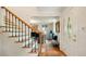 Bright foyer with hardwood floors, staircase with black iron railings, and views into the living room at 1434 Churchill Way, Marietta, GA 30062