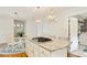 Kitchen island with granite countertops and gas cooktop near dining area and laundry room at 1434 Churchill Way, Marietta, GA 30062