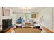 Bright living room with hardwood floors, fireplace, elegant decor, and large windows at 1434 Churchill Way, Marietta, GA 30062