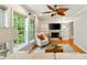 Cozy sun room with built-in shelving, fireplace, neutral decor, and large windows overlooking backyard at 1434 Churchill Way, Marietta, GA 30062