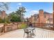Spacious wooden deck overlooking a fenced backyard with a garden, and mature trees at 1694 Jamie Leigh Ct, Snellville, GA 30078
