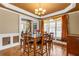 Dining room with hardwood floors, chandelier, large windows, and elegant finishes at 1694 Jamie Leigh Ct, Snellville, GA 30078