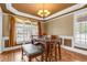 Bright dining area with a chandelier, large windows and custom wall trim detail at 1694 Jamie Leigh Ct, Snellville, GA 30078