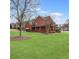 Large brick house with a beautiful lawn and mature trees at 1694 Jamie Leigh Ct, Snellville, GA 30078