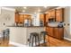 Kitchen with stainless steel appliances, bar seating, granite countertops, and warm wood cabinets at 1694 Jamie Leigh Ct, Snellville, GA 30078