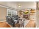 Comfortable living room with fireplace, TV, floating shelves, and large windows for natural light at 1694 Jamie Leigh Ct, Snellville, GA 30078