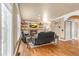 Cozy living room with fireplace, hardwood floors, and ample natural light from large windows at 1694 Jamie Leigh Ct, Snellville, GA 30078