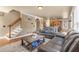 Open-concept living room with staircase, wood floors, and a view into the kitchen area at 1694 Jamie Leigh Ct, Snellville, GA 30078