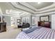 Cozy main bedroom featuring a fireplace, sitting area, and trey ceilings with a view to the on suite bath at 1694 Jamie Leigh Ct, Snellville, GA 30078