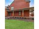 Rear view of the brick home, featuring a covered back porch at 1694 Jamie Leigh Ct, Snellville, GA 30078