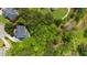 Aerial view of a wooded backyard lot, surrounded by mature trees providing shade and privacy at 2135 Glenfield Trce, Cumming, GA 30041