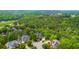 Aerial view of the neighborhood and surrounding trees showing the community at 2135 Glenfield Trce, Cumming, GA 30041