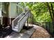 Backyard steps lead to the upper deck, showcasing the home's layout and outdoor living space at 2135 Glenfield Trce, Cumming, GA 30041