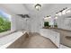 Bright bathroom featuring a glass shower, soaking tub, and granite counters at 2135 Glenfield Trce, Cumming, GA 30041