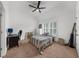 Neutral bedroom with a ceiling fan and large sunny window at 2135 Glenfield Trce, Cumming, GA 30041