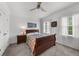 Bright bedroom with a warm color scheme, soft carpet, two windows, and modern furnishings at 2135 Glenfield Trce, Cumming, GA 30041
