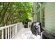 View of the outdoor deck area with a grill, nice white railing and wooded views at 2135 Glenfield Trce, Cumming, GA 30041