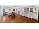 Open dining area showcases wood floors, a bar with seating, and views into the connected living spaces at 2135 Glenfield Trce, Cumming, GA 30041