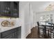 Elegant dining area with built-in bar space and a decorative chandelier providing ambient lighting at 2135 Glenfield Trce, Cumming, GA 30041