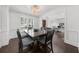 Dining room features a dark wood table, decorative chandelier, and classic trim work at 2135 Glenfield Trce, Cumming, GA 30041
