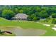 Scenic view of a lush golf course with a clubhouse, pond, and golf carts at 2135 Glenfield Trce, Cumming, GA 30041