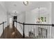 Bright hallway boasts dark wood floors, elegant staircase, and decorative chandelier enhancing the home's charm at 2135 Glenfield Trce, Cumming, GA 30041