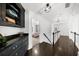 Hallway with hardwood floors, wainscoting, and a view into a bedroom at 2135 Glenfield Trce, Cumming, GA 30041