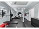 Home gym with rubber flooring, exercise equipment, ceiling fan, and large mirrors for training at 2135 Glenfield Trce, Cumming, GA 30041