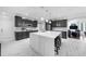 Modern kitchen featuring an island with seating and stainless steel appliances at 2135 Glenfield Trce, Cumming, GA 30041