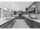 Spacious kitchen with gray cabinets, stainless steel appliances, and a large island at 2135 Glenfield Trce, Cumming, GA 30041