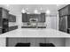 Modern kitchen featuring a large island with seating and stainless steel appliances at 2135 Glenfield Trce, Cumming, GA 30041