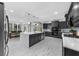 Open kitchen with gray cabinets, stainless steel appliances, and a large island with pendant lighting at 2135 Glenfield Trce, Cumming, GA 30041