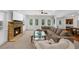 Spacious living room features a stone fireplace, plush sectional, modern coffee table, and an abundance of natural light at 2135 Glenfield Trce, Cumming, GA 30041