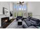 Bright living room with fireplace, soaring windows, and comfortable blue couches at 2135 Glenfield Trce, Cumming, GA 30041