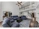 Bright living room with dark wood floors and comfortable blue couches at 2135 Glenfield Trce, Cumming, GA 30041